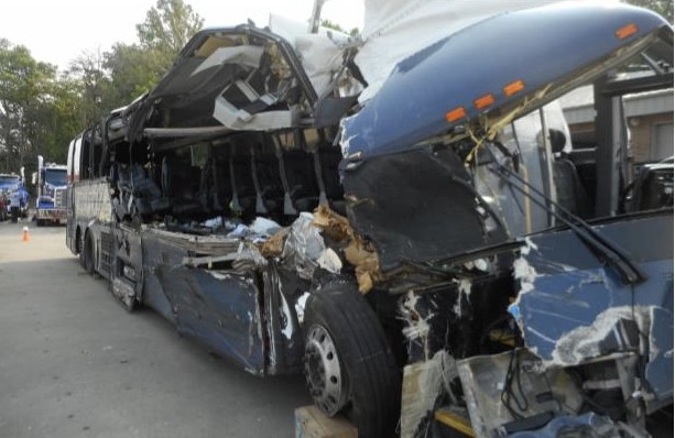 Postcrash photo of the Greyhound motorcoach looking down the right side of the motorcoach from the front.